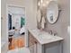 Modern bathroom with dual sink vanity, marble countertop and floors, and access to bedroom at 2418 Bolling Brook Sw Dr, Atlanta, GA 30311
