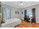 Cozy bedroom with a desk area, natural light, and hardwood floors at 2418 Bolling Brook Sw Dr, Atlanta, GA 30311