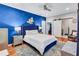 Comfortable bedroom featuring blue accent wall, ceiling fan, and walk-in closet at 2418 Bolling Brook Sw Dr, Atlanta, GA 30311