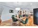 Dining room with pendant lighting, hardwood floors and an open view to the living room at 2418 Bolling Brook Sw Dr, Atlanta, GA 30311