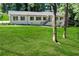 Traditional single-Gathering home showcasing a well-manicured lawn and landscaped front yard at 2418 Bolling Brook Sw Dr, Atlanta, GA 30311