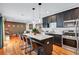 Stylish kitchen with a large island, pendant lights, stainless steel appliances, and an open view to the living area at 2418 Bolling Brook Sw Dr, Atlanta, GA 30311