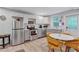Well-equipped kitchen with stainless steel appliances and a cozy dining area bathed in natural light from a nearby window at 2418 Bolling Brook Sw Dr, Atlanta, GA 30311