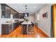 Modern kitchen boasts dark cabinetry, stainless steel appliances, and a center island with wine cooler and bar seating at 2418 Bolling Brook Sw Dr, Atlanta, GA 30311