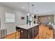 Open concept kitchen featuring an island with bar seating and pendant lighting, seamlessly connected to the living area at 2418 Bolling Brook Sw Dr, Atlanta, GA 30311