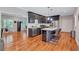 Spacious kitchen featuring an island with a wine cooler and seating, flowing into the adjacent living area at 2418 Bolling Brook Sw Dr, Atlanta, GA 30311