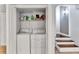 A bright laundry room with a washer and dryer and shelving for storage at 2418 Bolling Brook Sw Dr, Atlanta, GA 30311