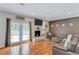 Inviting living room features a painted brick fireplace, French doors, and a comfortable sectional sofa at 2418 Bolling Brook Sw Dr, Atlanta, GA 30311