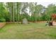 Expansive backyard featuring a storage shed, green grass, and a wood fence at 2420 Westport Cir, Marietta, GA 30064