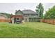 Spacious backyard featuring a patio, wood fence, and green two story home at 2420 Westport Cir, Marietta, GA 30064