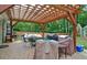 Backyard patio with pergola, seating area, barbecue grill, and lush green surroundings at 2420 Westport Cir, Marietta, GA 30064