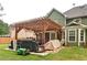 Backyard patio with pergola and grilling area, attached to a two-story home with fenced yard at 2420 Westport Cir, Marietta, GA 30064