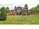 A large backyard with a green lawn, wooden fence and a covered patio, perfect for outdoor entertaining at 2420 Westport Cir, Marietta, GA 30064