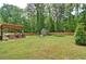 Expansive backyard featuring a patio, shed, swing set, and trampoline, enclosed by a wooden fence at 2420 Westport Cir, Marietta, GA 30064