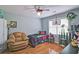 Cozy bedroom with hardwood floors, a ceiling fan, and a comfortable seating area at 2420 Westport Cir, Marietta, GA 30064