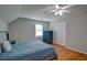 Bright bedroom featuring a ceiling fan, hardwood floors, and neutral decor at 2420 Westport Cir, Marietta, GA 30064