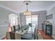 Elegant dining room featuring hardwood floors, stylish lighting, and a large dining table at 2420 Westport Cir, Marietta, GA 30064