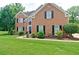 Charming two-story brick home with a well-manicured front yard and classic black shutters at 2420 Westport Cir, Marietta, GA 30064