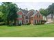 Classic brick home with a manicured lawn, black shutters, and an inviting front entrance for curb appeal at 2420 Westport Cir, Marietta, GA 30064