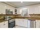 Modern kitchen with stainless steel appliances, granite counters, and updated cabinetry at 2420 Westport Cir, Marietta, GA 30064