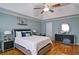 Comfortable main bedroom features a queen bed, wood flooring, and stylish decor at 2420 Westport Cir, Marietta, GA 30064