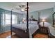 Comfortable main bedroom with hardwood floors, large window and ceiling fan at 2420 Westport Cir, Marietta, GA 30064