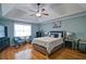 Inviting bedroom featuring a ceiling fan, hardwood floors, and plenty of natural light at 2420 Westport Cir, Marietta, GA 30064