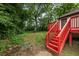 Exterior home view with a red deck and grassy backyard and stairs at 429 Deckner Sw Ave, Atlanta, GA 30310