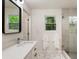 Renovated bathroom featuring a glass shower, undermount sink, geometric tile, and natural light at 429 Deckner Sw Ave, Atlanta, GA 30310