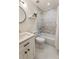 Bright bathroom featuring marble tiled shower, modern sink, round mirror, and hexagon tile flooring at 429 Deckner Sw Ave, Atlanta, GA 30310