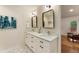 Bright bathroom with double vanity, framed mirrors, modern fixtures, and geometric tile flooring at 429 Deckner Sw Ave, Atlanta, GA 30310