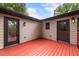 Spacious red painted deck featuring doors to the home's interior, enhancing outdoor-indoor living at 429 Deckner Sw Ave, Atlanta, GA 30310