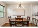 Cozy dining area with a wooden table, modern light fixture, and view into the kitchen at 429 Deckner Sw Ave, Atlanta, GA 30310
