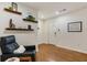 Bright foyer with hardwood floors, floating shelves, and a white paneled front door at 429 Deckner Sw Ave, Atlanta, GA 30310