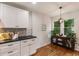 Bright kitchen nook featuring lots of natural light, white walls, and wood flooring at 429 Deckner Sw Ave, Atlanta, GA 30310