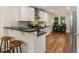 Modern kitchen with white cabinets, stainless steel appliances, and a breakfast bar at 429 Deckner Sw Ave, Atlanta, GA 30310