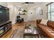 Comfortable living room featuring hardwood floors, a leather sofa, and stylish decor at 429 Deckner Sw Ave, Atlanta, GA 30310