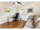 Well-lit home office with a desk, a couch, and hardwood floors at 429 Deckner Sw Ave, Atlanta, GA 30310