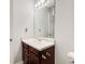 Classic bathroom with wooden cabinet and large rectangular mirror at 468 Berkshire Place, Fairburn, GA 30213
