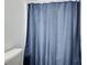 Cozy bathroom featuring blue shower curtain and white wall at 468 Berkshire Place, Fairburn, GA 30213