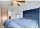 Well-lit bedroom featuring a tufted headboard bed and wood floors at 468 Berkshire Place, Fairburn, GA 30213