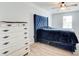 Bedroom featuring a white dresser and a tufted bed with wood floors at 468 Berkshire Place, Fairburn, GA 30213