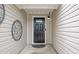 Inviting front entrance featuring a black front door with sidelights and decorative metal art at 468 Berkshire Place, Fairburn, GA 30213