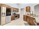 Well-lit kitchen with granite countertops, stainless steel appliances, and ample cabinet space at 468 Berkshire Place, Fairburn, GA 30213