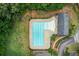 Aerial view of a pristine blue swimming pool with surrounding greenery at 468 Berkshire Place, Fairburn, GA 30213
