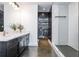 Contemporary bathroom featuring a sleek vanity, open shelving, and glass-enclosed shower at 845 Spring Street Northwest Nw St # 307, Atlanta, GA 30308