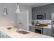 Modern kitchen with stainless steel appliances, stylish lighting, and marble countertops at 845 Spring Street Northwest Nw St # 307, Atlanta, GA 30308