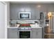 Kitchen with grey cabinets, stainless steel appliances, and marble countertops at 845 Spring Street Northwest Nw St # 307, Atlanta, GA 30308
