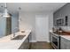 Modern kitchen with stainless steel appliances, stylish lighting, and marble countertops at 845 Spring Street Northwest Nw St # 307, Atlanta, GA 30308