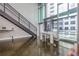 Open-concept living room with large windows, a staircase, and views of the city at 845 Spring Street Northwest Nw St # 307, Atlanta, GA 30308